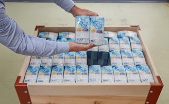 Schweizer Nationalbank senkt Leitzins - Palette mit 100 Franken Noten.
